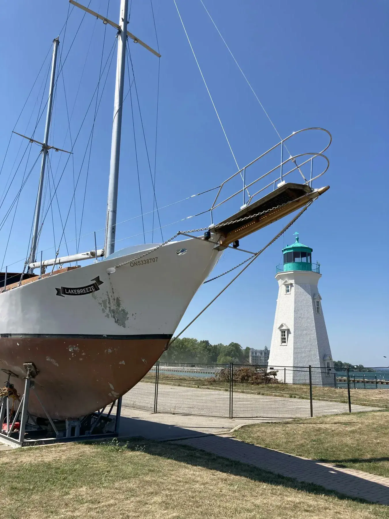 Ship and lighthouse by the water in Port Dalhousie St. Catharines