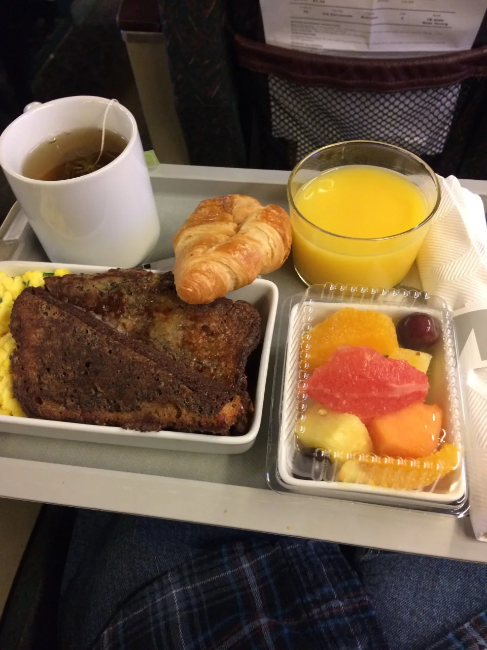 VIA Rail Business Class breakfast tray with eggs, French toast, a croissant, fruit, orange juice and tea