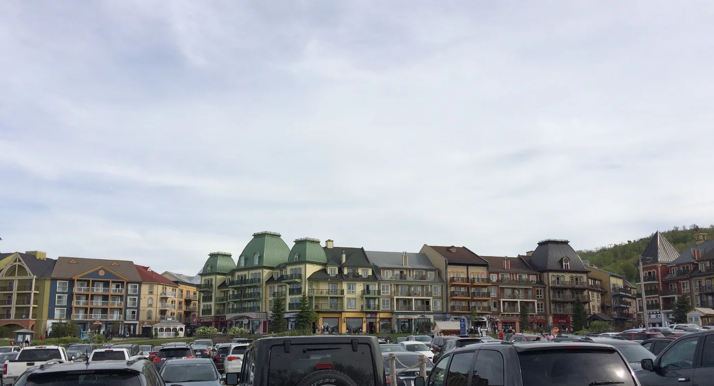 Blue Mountain Village edge and nearby parking area under a bright sky