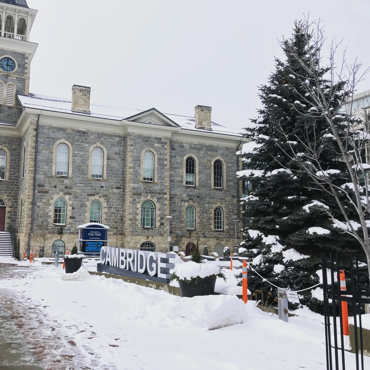 Cambridge Ontario City Hall in winter with snow and the Cambridge sign