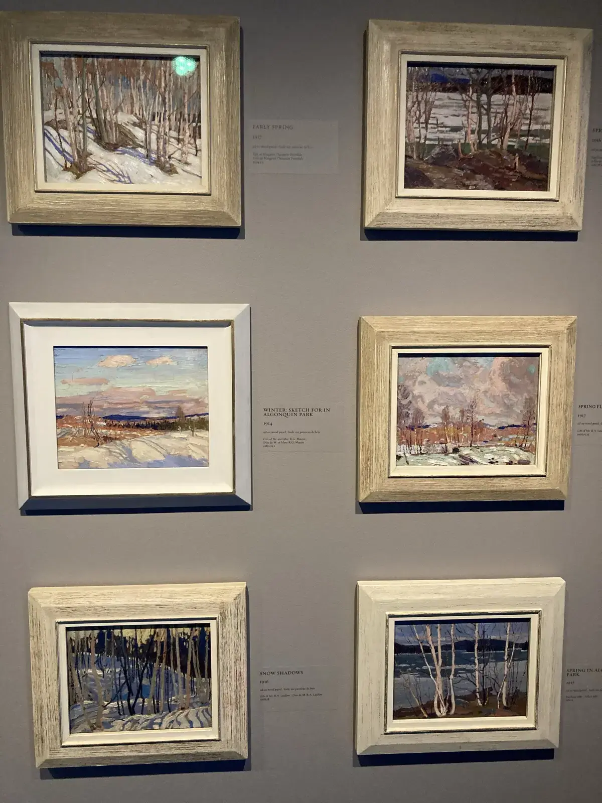 Wall of Canadian landscape paintings inside the McMichael gallery