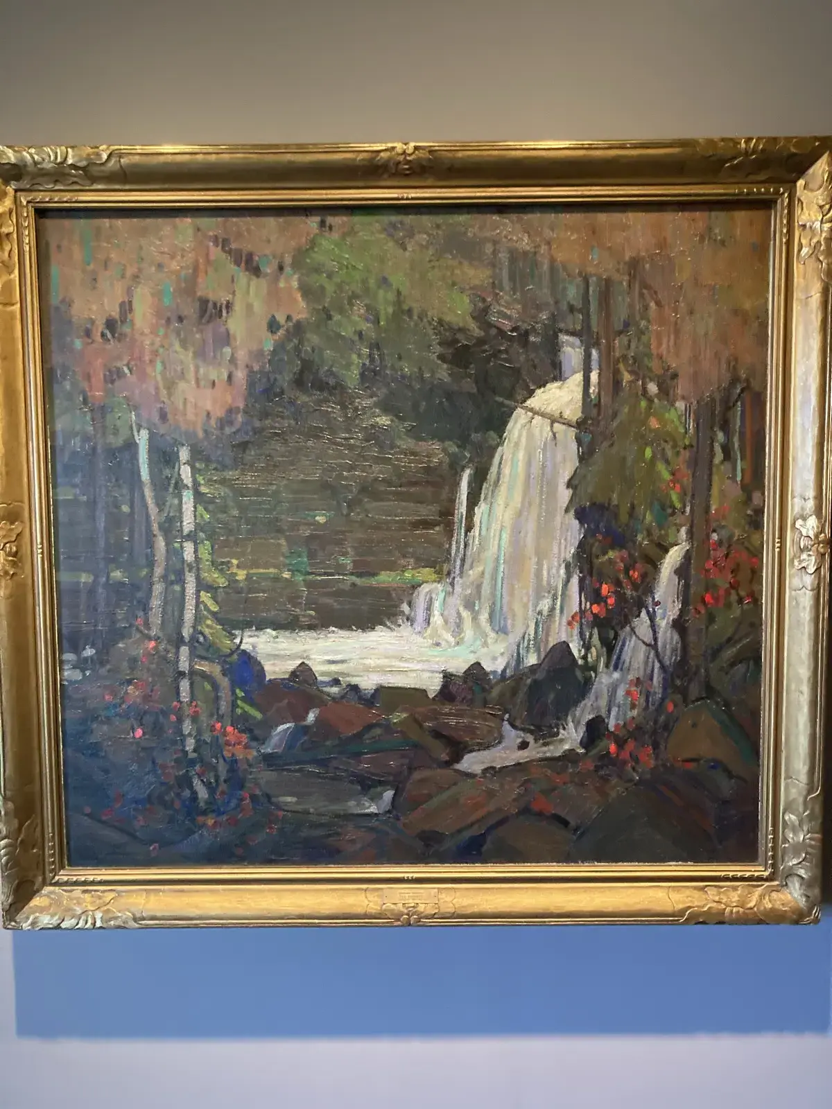 Framed waterfall landscape painting inside the McMichael Canadian Art Collection