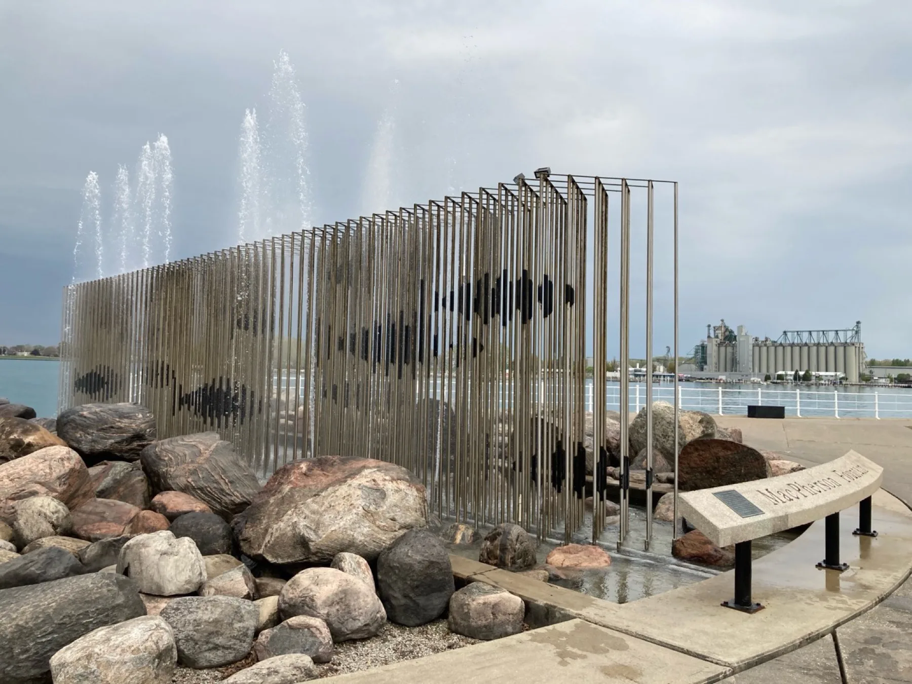 Water feature and public art on the Sarnia riverfront with the St. Clair River behind it