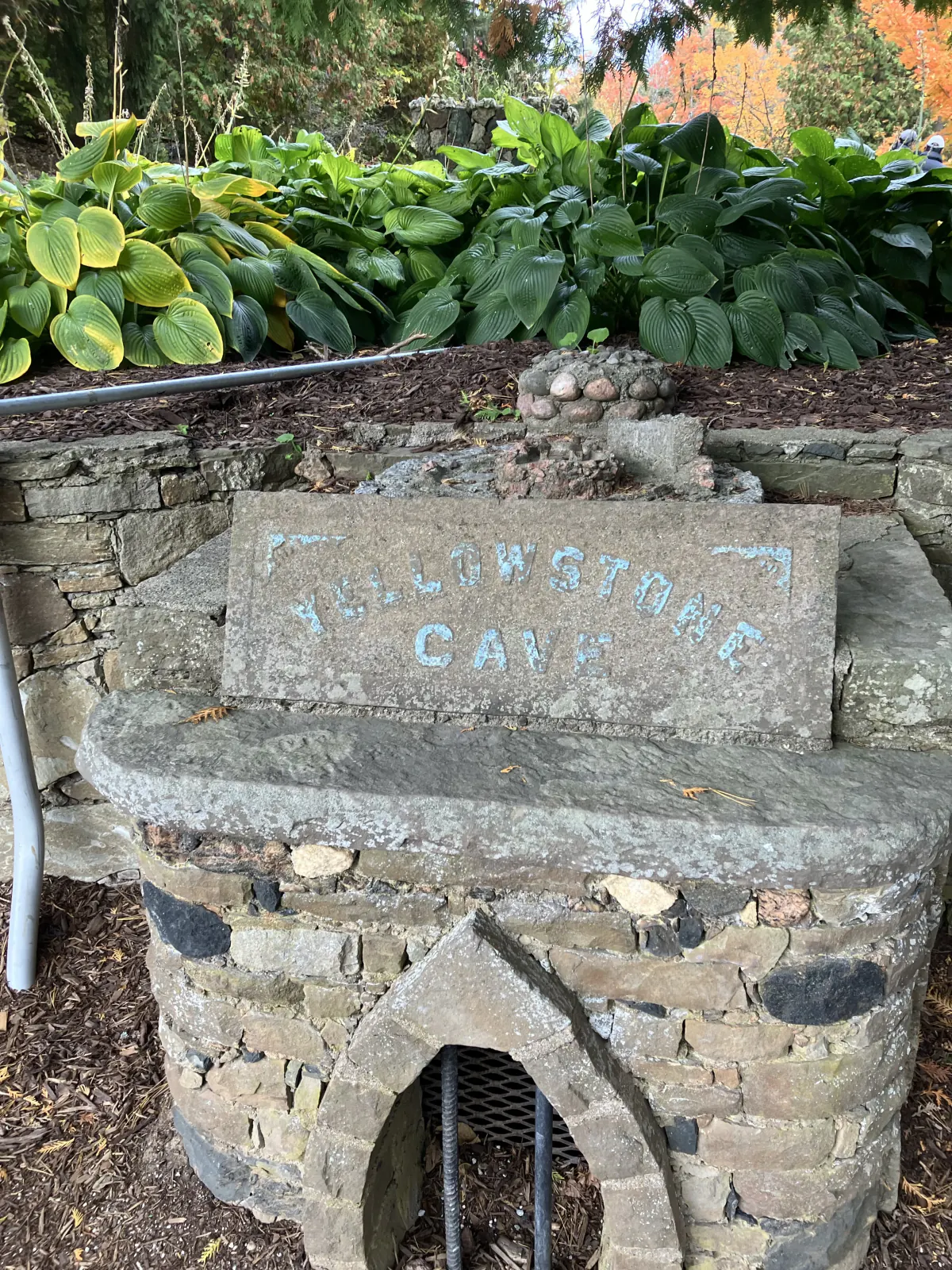 Weathered stone sign reading Yellowstone Cave at Belfountain Conservation Area