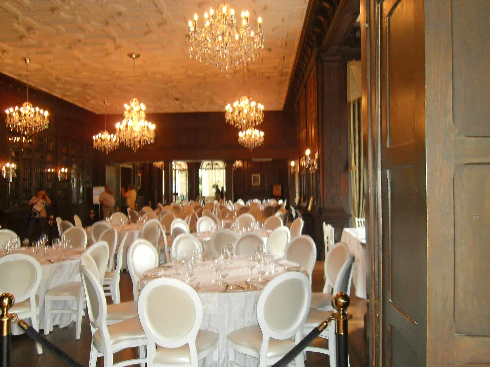 Chandeliers and banquet tables in a Casa Loma hall