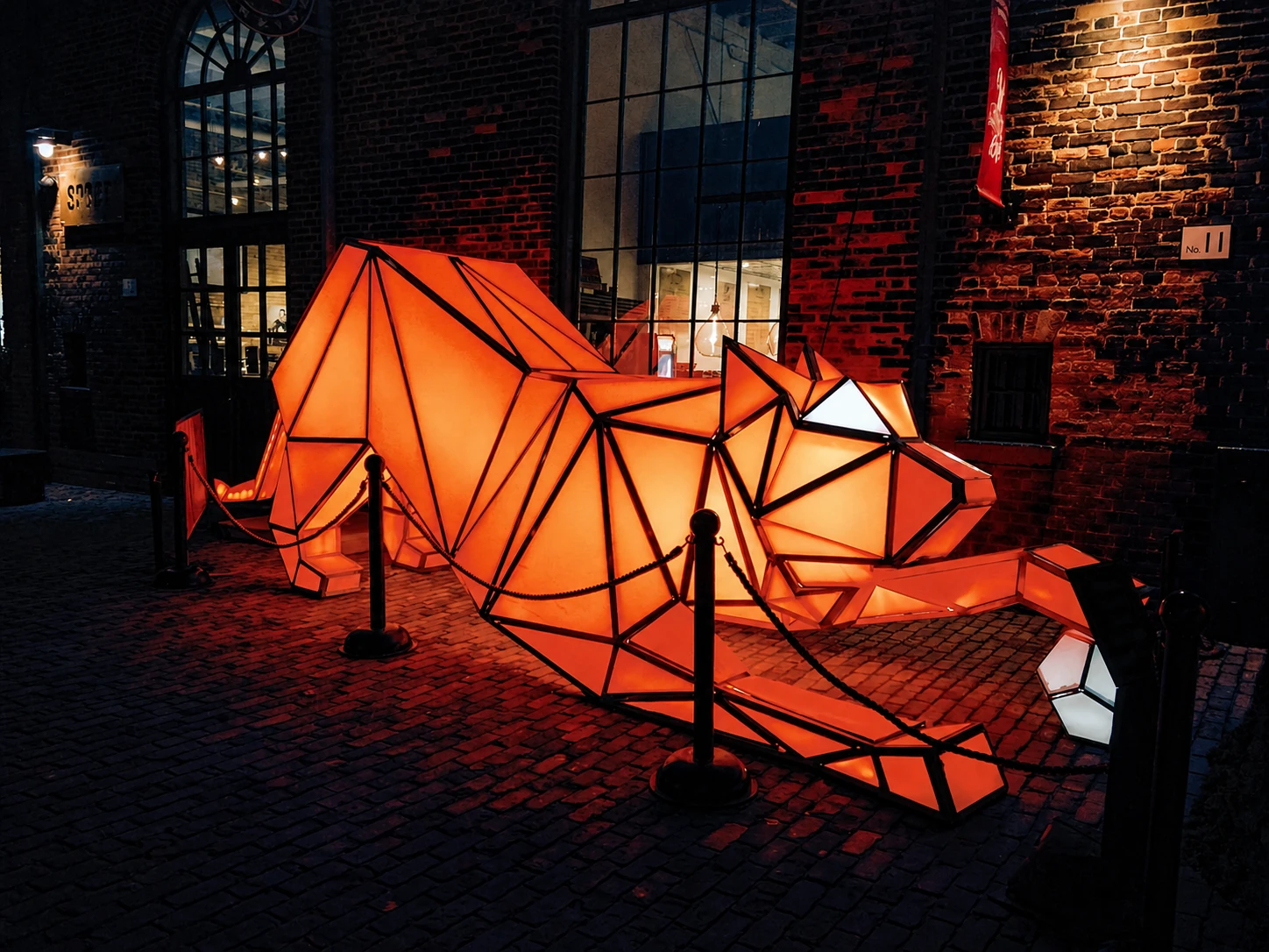 Geometric glowing fox installation on Distillery District cobblestones
