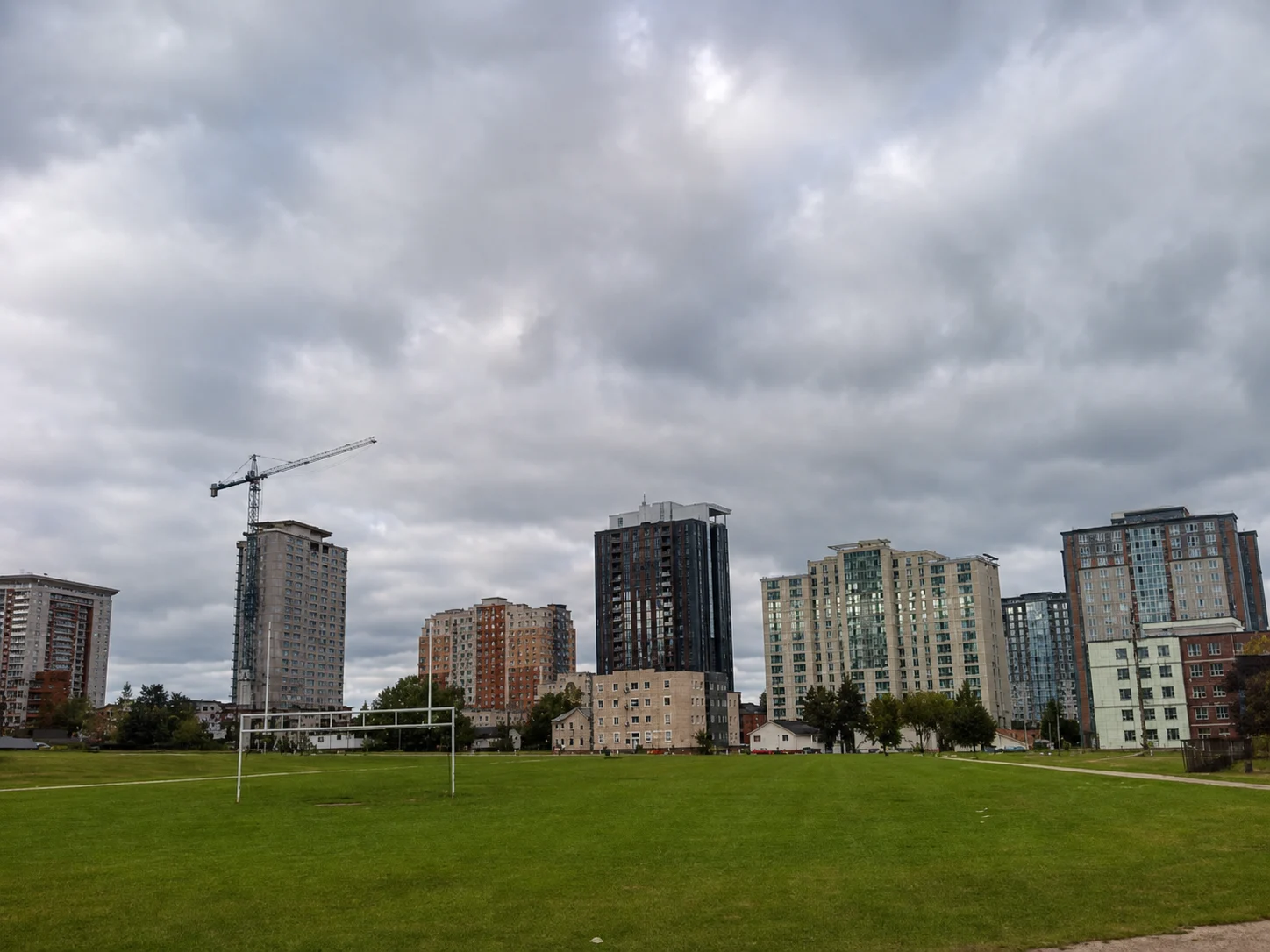 Waterloo Ontario construction boom skyline with new residential towers beyond a field