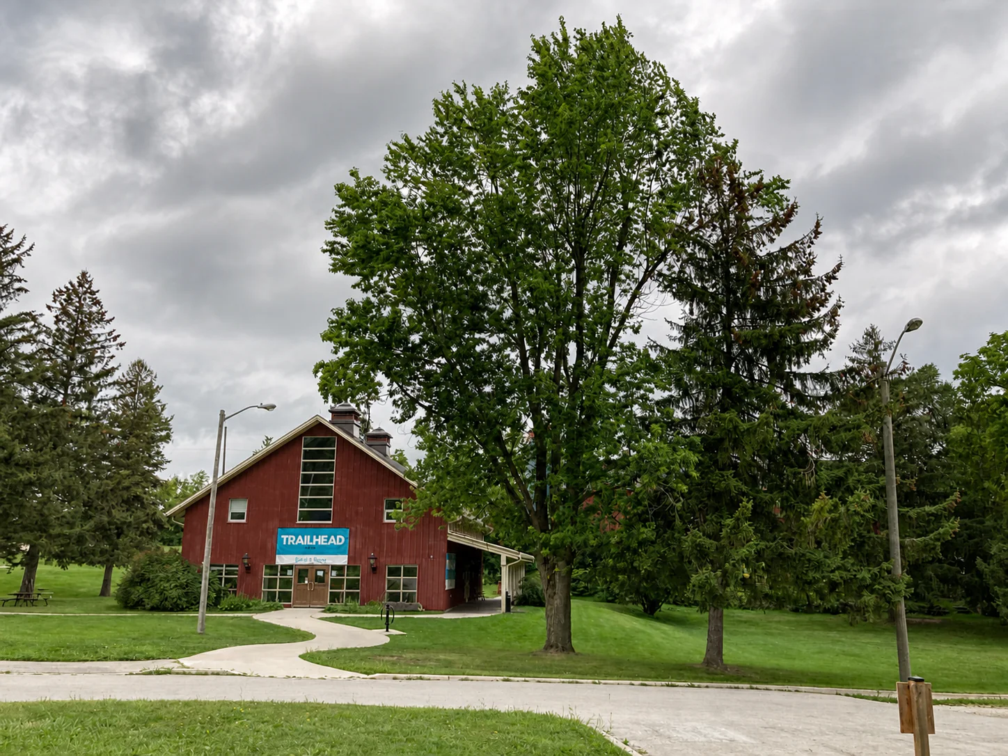 Red Trailhead building surrounded by mature trees at Kelso Conservation Area