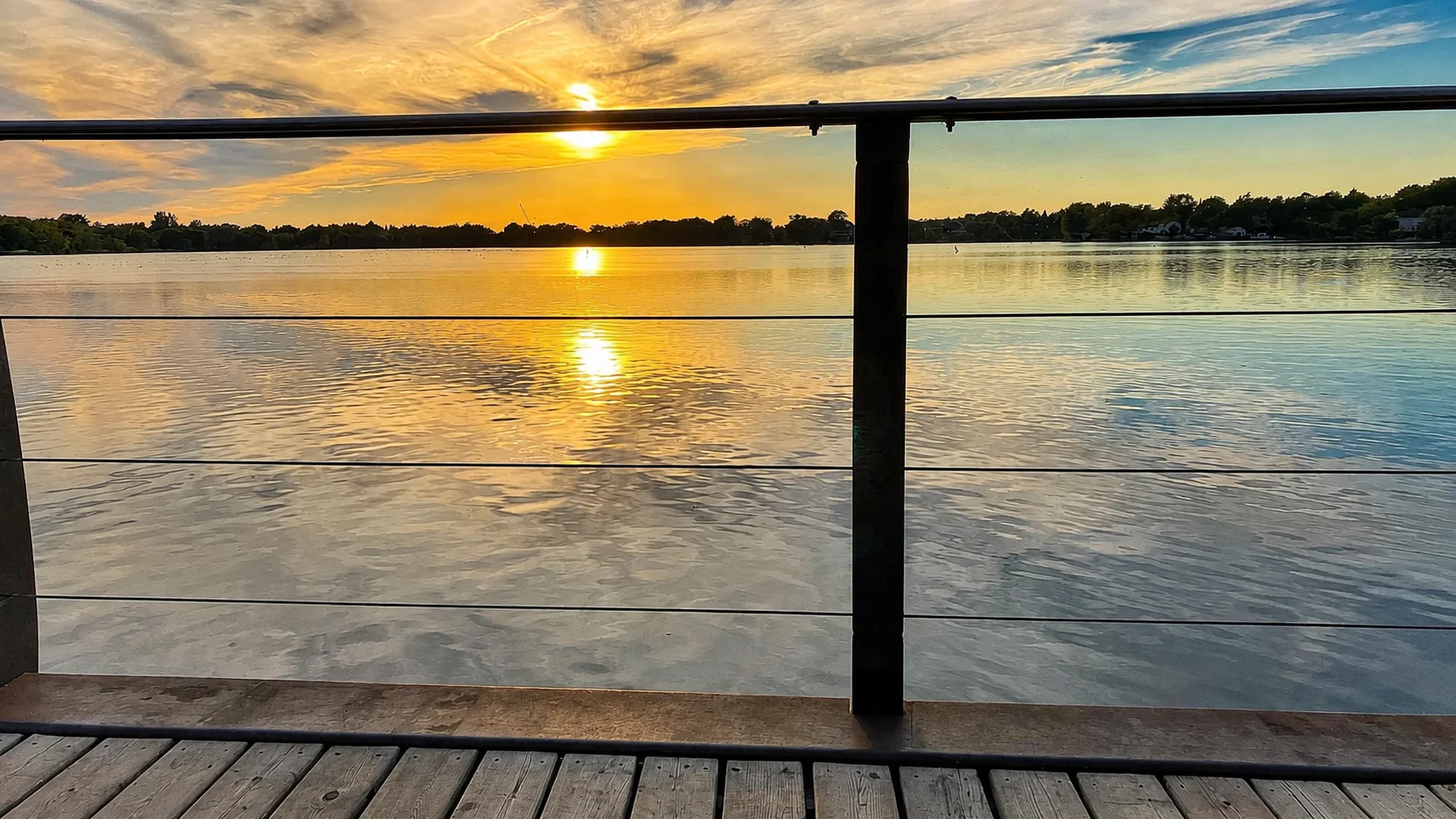 A warm reflection across the water from the Lake Wilcox boardwalk.