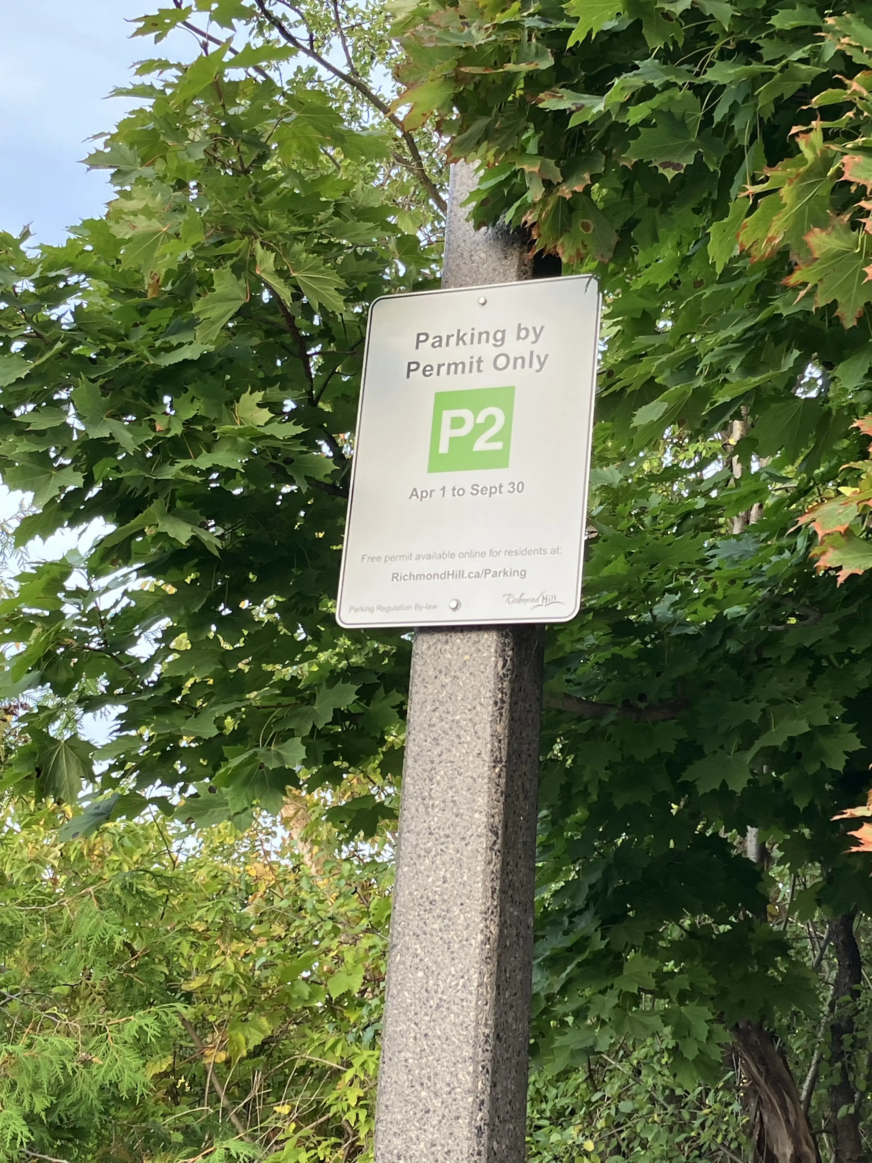 Original P2 parking sign photographed at Lake Wilcox: permit rules apply; check current city instructions.