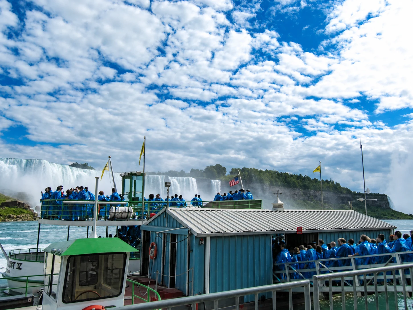 Blue-poncho boat passengers approaching the Niagara Falls mist