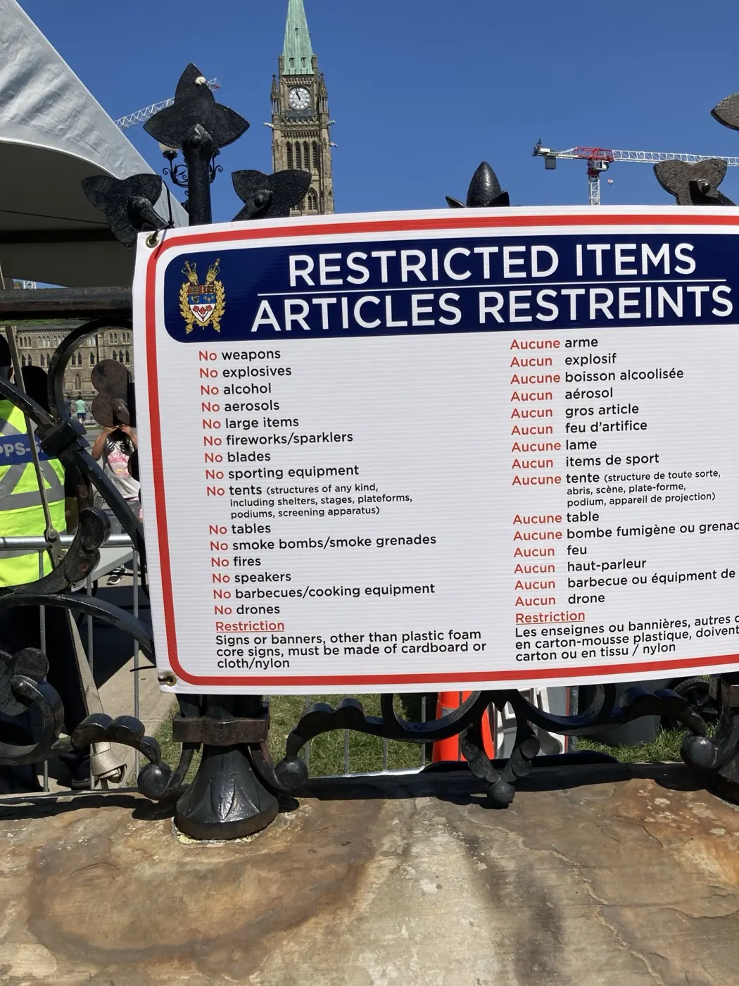 Restricted items sign outside Parliament Hill in Ottawa with the Peace Tower behind it