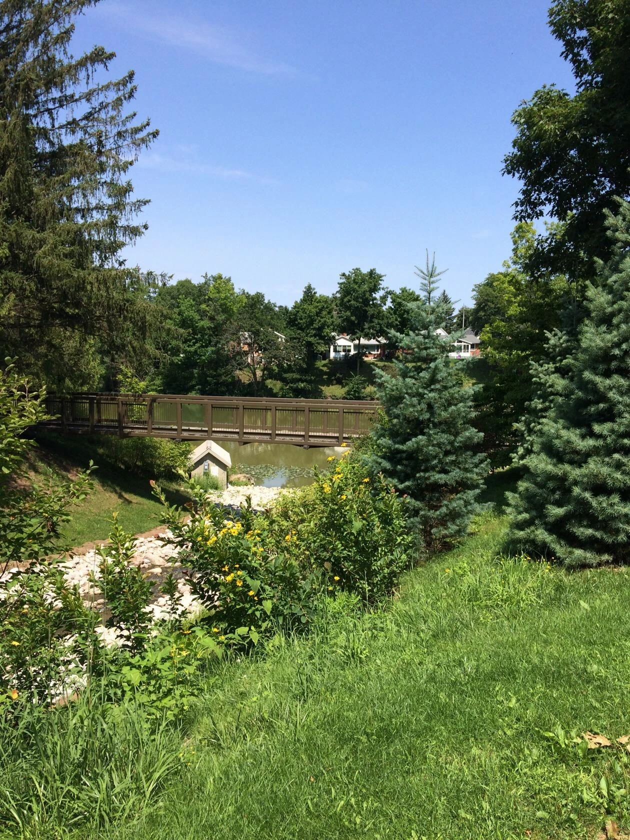 Pinafore Park pond and bridge with colourful seasonal canoes nearby