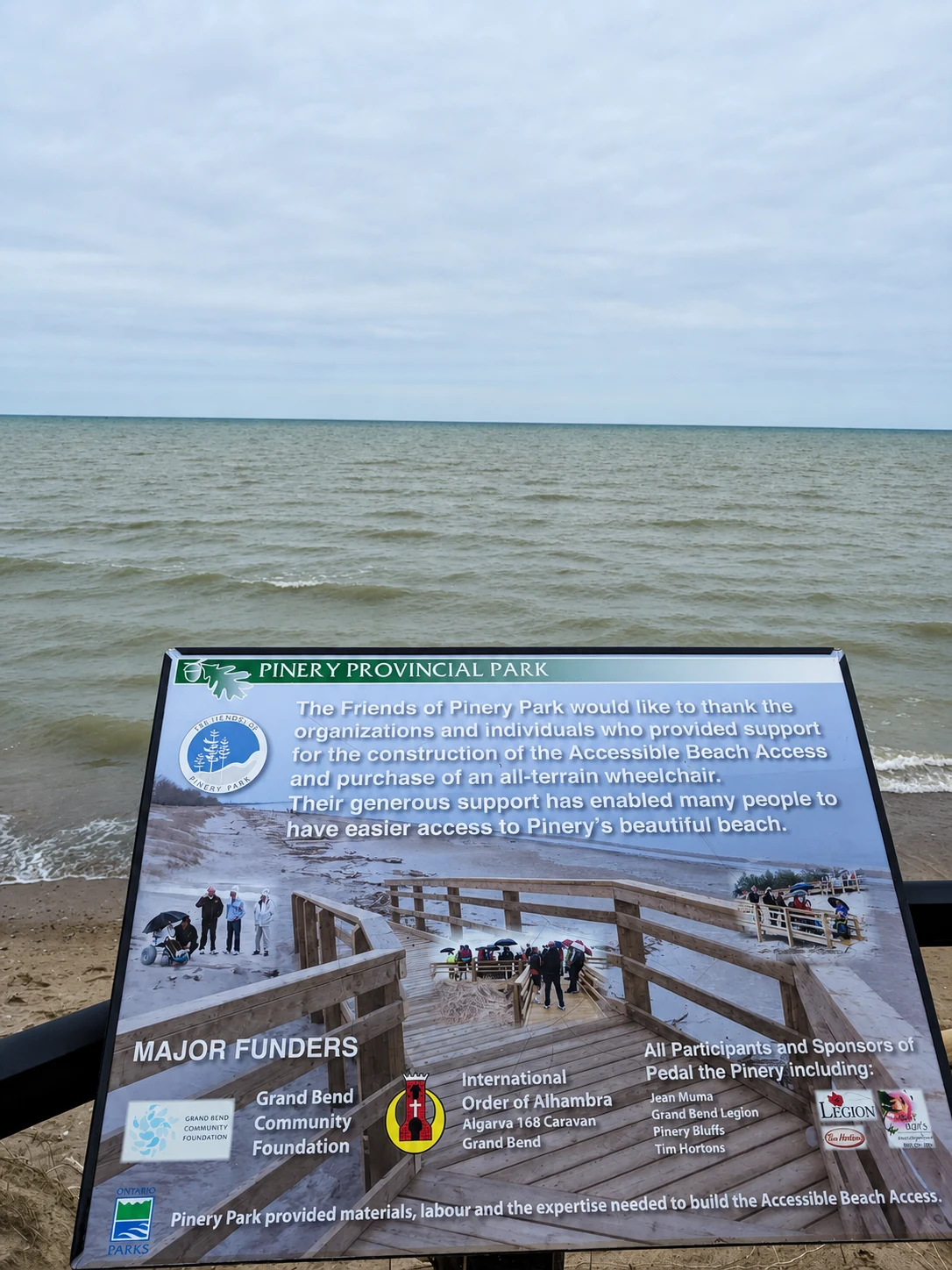 Lake Huron shoreline and accessible beach information sign at Pinery Provincial Park