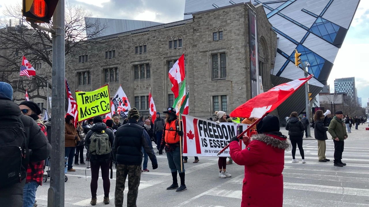 Wide view of a Trudeau-era anti-government gathering at the Queen's Park and Bloor intersection