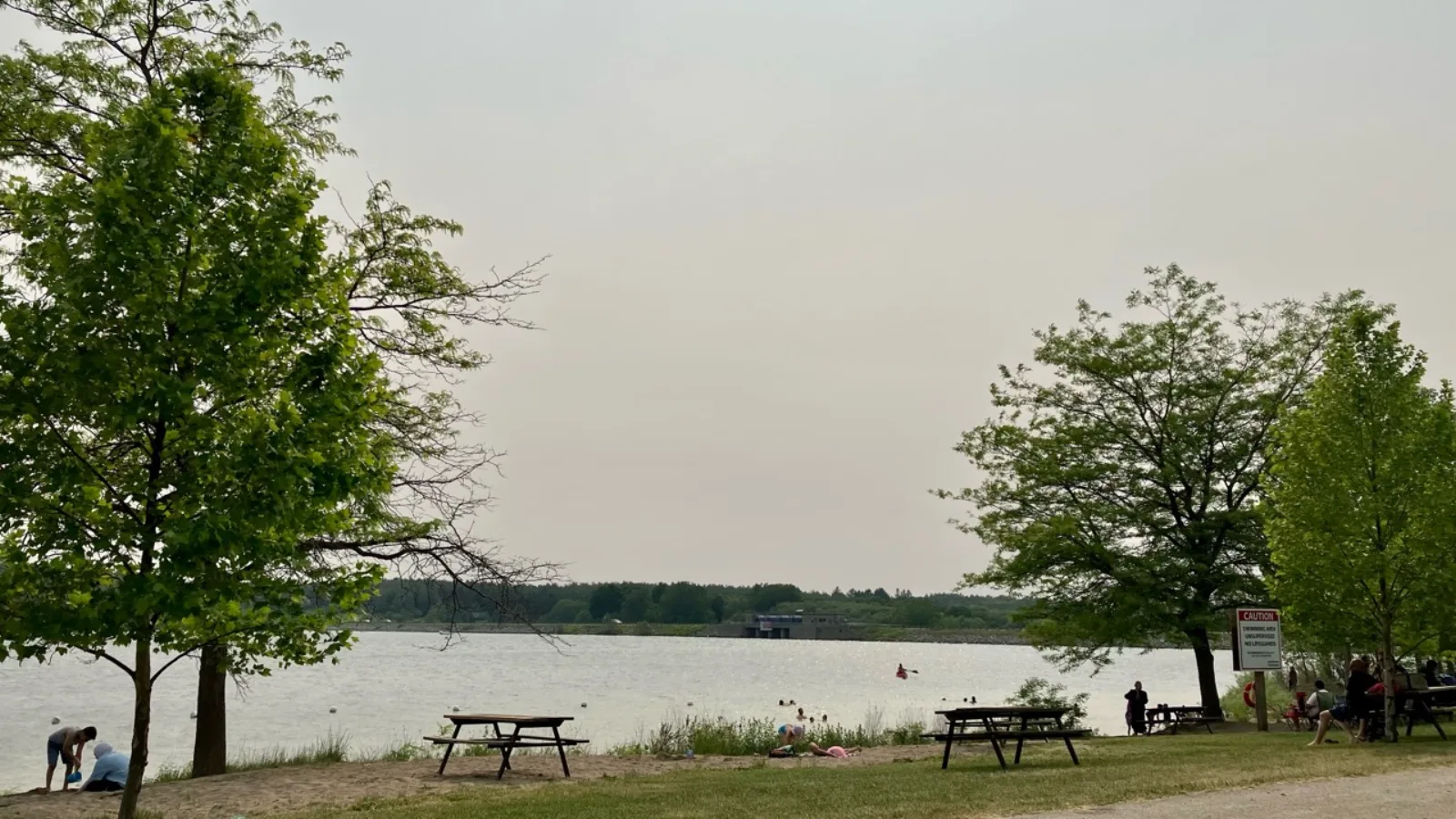 Wildwood Reservoir swimming beach with shaded picnic tables